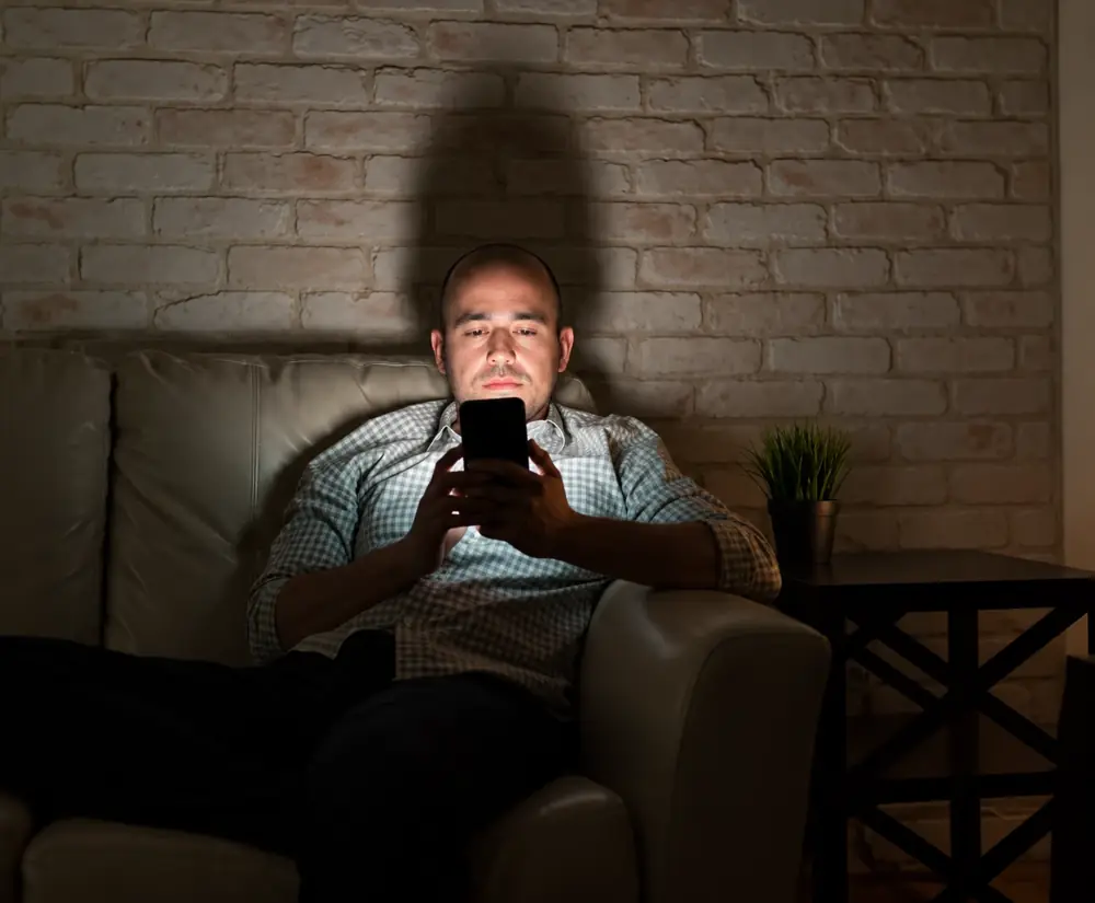 Central Florida homeowner on his phone late at night contacting a 24/7 mold inspector