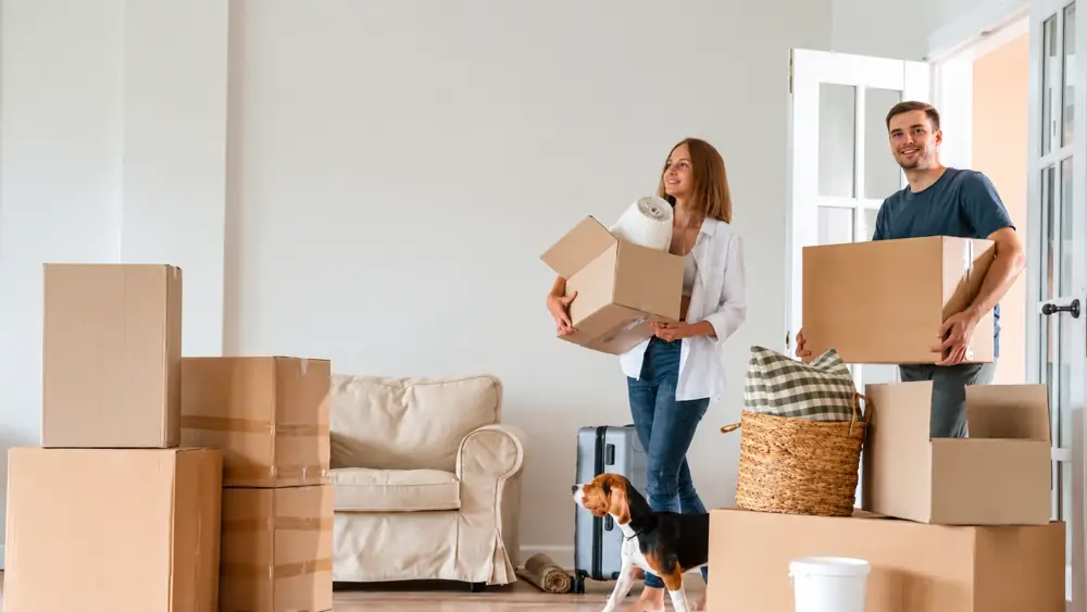 Couple carrying moving boxes into their newly inspected Central Florida home